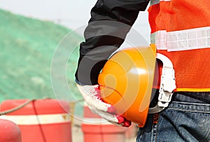 Safety work concept, construction worker holding helmet photo