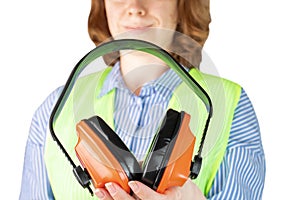 Safety work protective accessories, anti noise headphones, ear protectors for workers in noisy production, woman in overalls