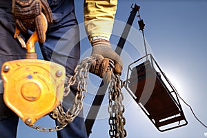 Safety workplace close up image of trained competent rigger high risk worker wearing safety heavy duty glove inspecting lifting ch