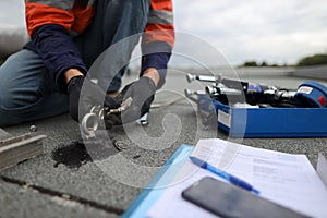 Trained safety auditor  inspecting industrial rope access working at heights fall arrest, abseiling stainless 16 MM photo