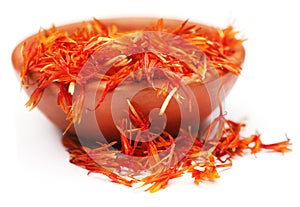 Safflower petals on a brown bowl