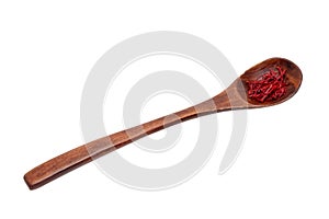 Saffron background. Close-up of red safran spice threads or strands in a rustic wooden spoon isolated on a white background.