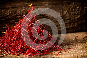 Saffron crocus threads on dark wooden background