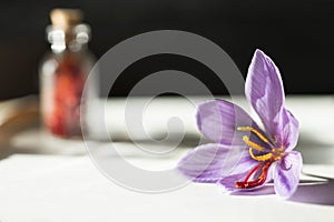 Saffron flower and dried saffron spice in a bottle