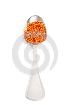 Saffron in iron spoon isolated on white background.