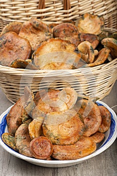 Saffron milk caps in baskets and bowls on the kitchen table