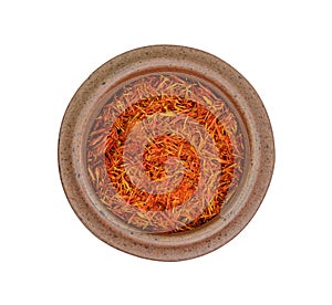Saffron pistil in a bowl on white. Saffron spice threads.