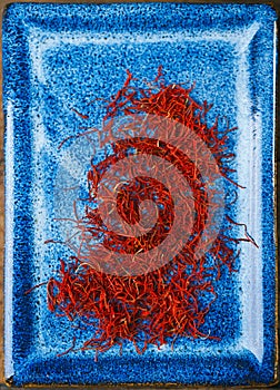 Saffron space threads in blue plate bowl