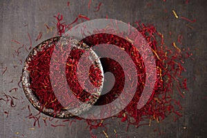 Saffron spice threads and powder in vintage iron dish