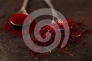 Saffron spice threads and powder in vintage old spoons
