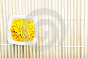 Saffron spice in white dish on mat