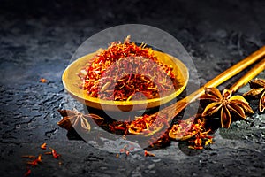 Saffron. Various Indian Spices on black stone table. Spice and herbs on slate background