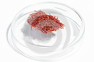Safron spice macro isolated on glass bowl