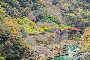 Sagano Romantic train running above river Kyoto Japan