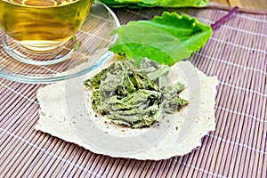 Sage dried on paper with cup on board