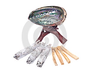 Sage smudge stick, rainbow abalone shell and palo santo smudging sticks photo