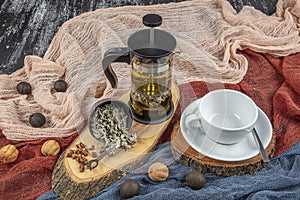 Sage tea in flass mug and sage leaves on wooden table, selective focus with shallow depth of field