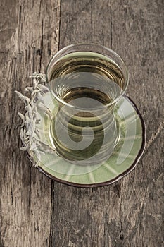 Sage tea on wooden table