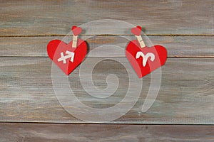Sagittarius and Aries. signs of the zodiac and heart. wooden bac