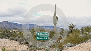 Saguaro Cactus with Phoenix and Flagstaff Arizona Sign Closeup