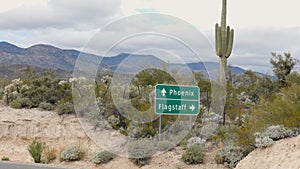 Saguaro Cactus with Phoenix and Flagstaff Arizona Sign Zoom Out