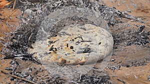 Sahara bread baking in the ground in the desert landscape of the Sahara Desert near Douz, Tunisia.Sahara bread baking in the groun