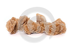 Sahara desert mineral rose isolated on white background. Unfading flower. Bizarre stones. the aggregate of gypsum crystals that