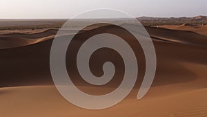 Sahara desert sand dunes landscapes at sunrise, Mhamid, Erg Chigaga, Morocco.