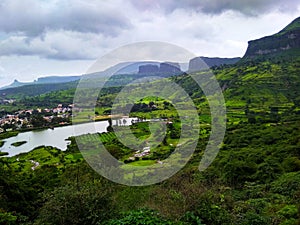 Sahyadri mountain slope greenary with pond and farm