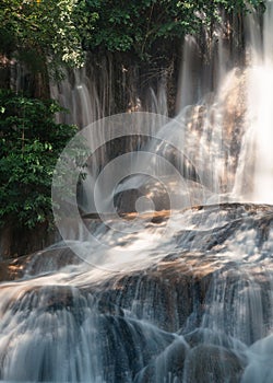 Sai Yok Noi waterfall flowing on limestone in tropical rainforest at national park