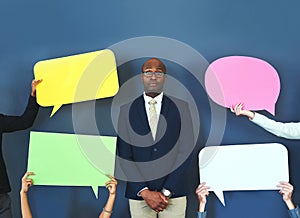 They said it, not me. Cropped shot of people holding up speech bubble around a young man.