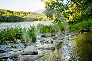 Saide stream falling into Neris river in Neris Regional Park near Vilnius, on sunny summer day