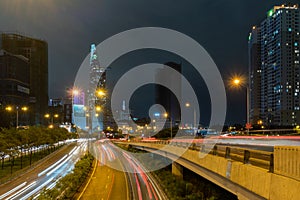 Saigon Cityscape Nighttime. Urban Metropolis with illuminated road and Bitexco Financial Tower at Background. Saigon