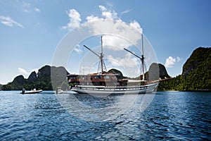 Sail boat between islands of remote archipelago Pulau Wayag, Raja Ampat, Indonesia