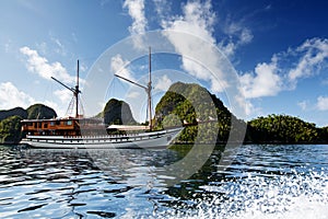 Sail boat between islands of remote archipelago Pulau Wayag, Raja Ampat, Indonesia