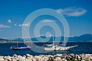 Sail boat on mountains background on the gulf of Naples in Italy.