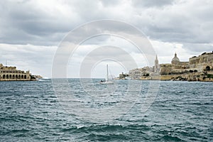 Sail boat navigating at Marsamxett Harbor photo