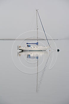 Sail boat reflected in the water