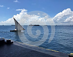 A sail boat underway at sea, view from deck of a ship