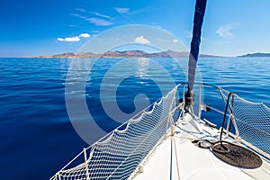 Sail boat - yachting in open sea near island photo