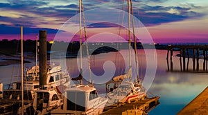 Sail boats docked on marine in beautiful sunset