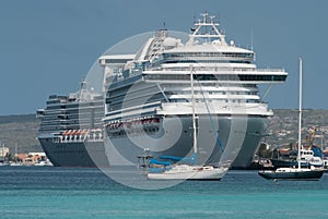 Sail boats and large cruise ships docked at the port of Klarendijk