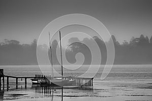 Sail boats moored at Lake Wendouree jetty on a cold misty morning