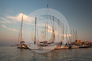 Sail boats and yachts anchored in marina.