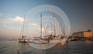 Sail boats and yachts anchored in marina.