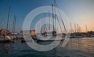 Sail boats and yachts anchored in marina.