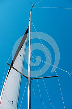 Sail of a sailing boat against blue sky