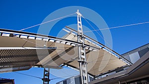 Sail shade pergola made of galvanized steel and stainless steel wire cable tall structure against the blue sky d