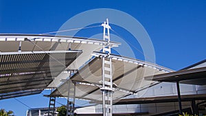 Sail shade pergola made of galvanized steel and stainless steel wire cable tall structure against the blue sky d