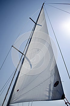 Sail yacht on the background of blue sky